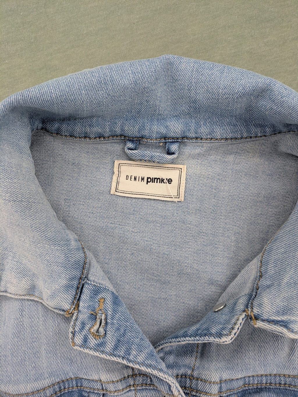 Pimkie blue denim jacket with classic cut, button placket, and two chest pockets.