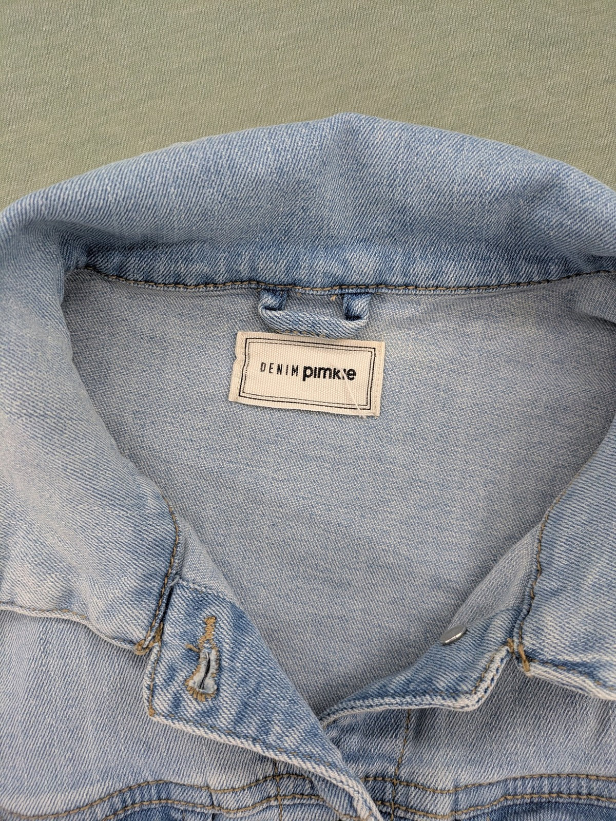 Pimkie blue denim jacket with classic cut, button placket, and two chest pockets.