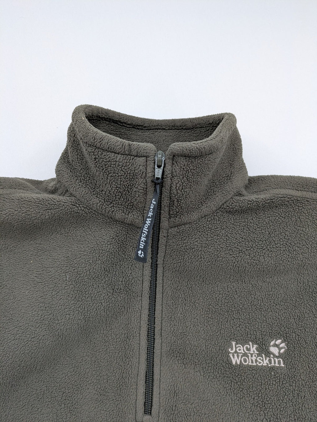 Jack Wolfskin khaki turtle neck jumper with quarter zip and embroidered paw logo.