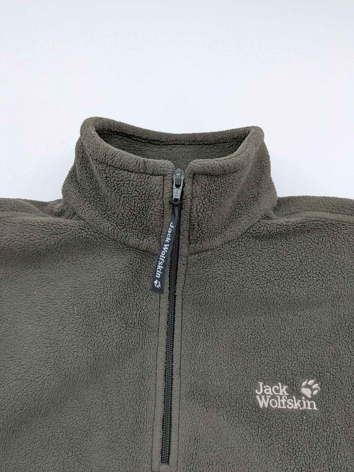 Jack Wolfskin khaki turtle neck jumper with quarter zip and embroidered paw logo.
