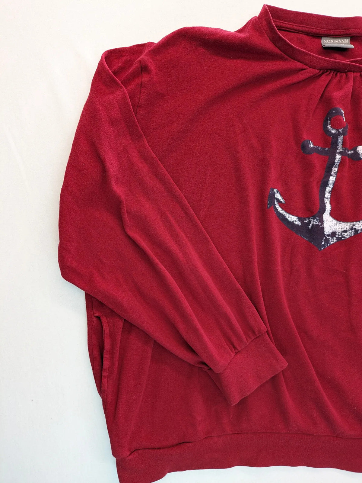 Normann red turtle neck jumper with large anchor print and side pockets.