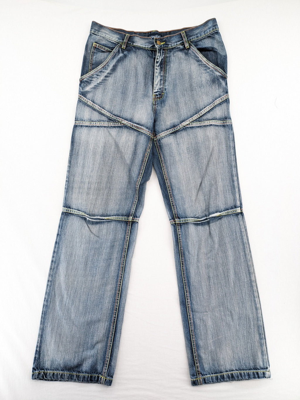 Identic orange straight jeans with paneled design and contrasting yellow stitching.