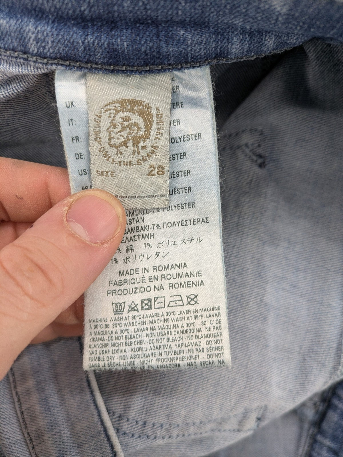 Diesel blue bootcut jeans with white patch pockets and regular waist, stylish stretch material.