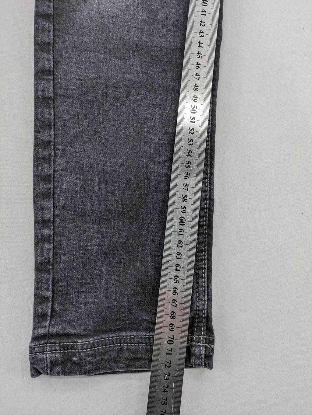 Tom Tompson grey slim tapered jeans with washed denim finish and subtle branding.