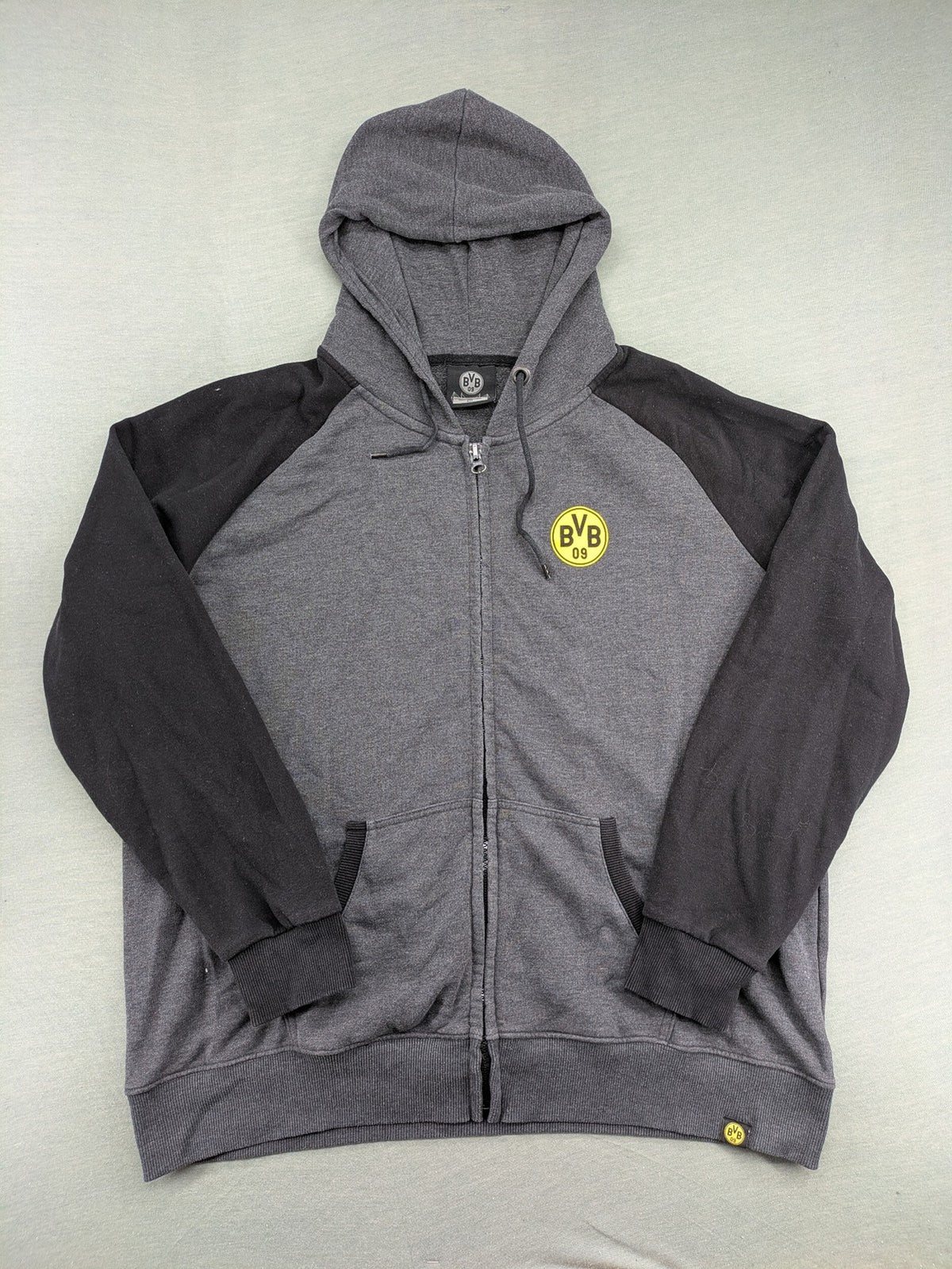 Borussia Dortmund grey and black hoodie with BVB 09 logo and full zip design.