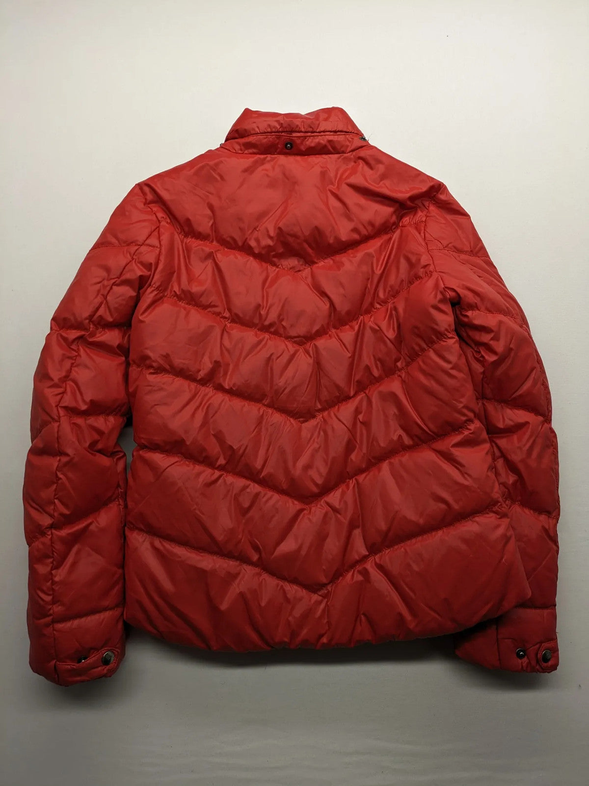 Hilfiger Denim red down jacket with quilted design, stand collar, and zip closure.
