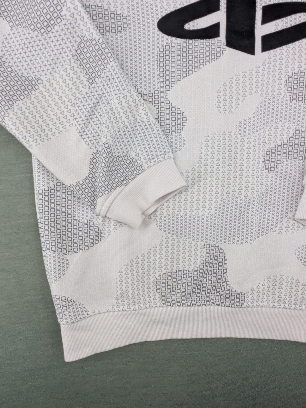PlayStation grey sweatshirt with white logo and camo pattern featuring controller symbols.