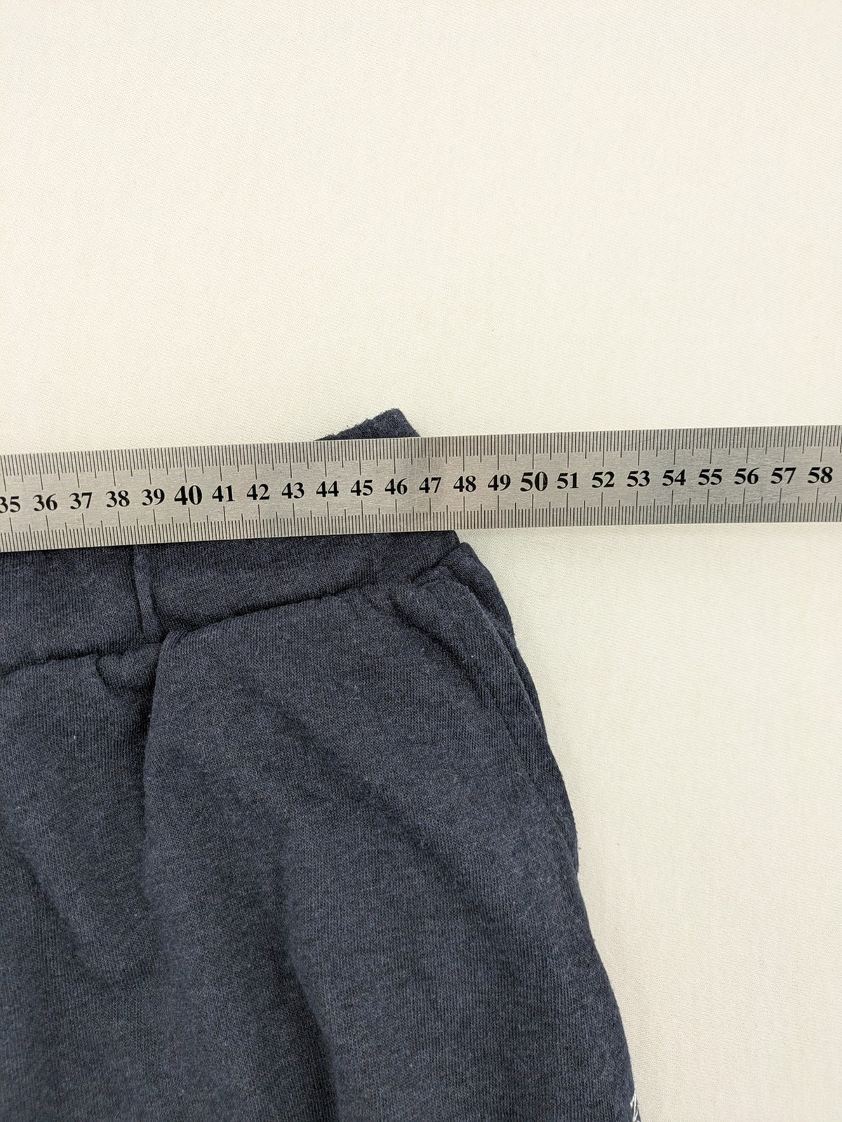 Livergy blue sweatshorts with embroidered "Blue Water Champion" logo and adjustable drawstring.