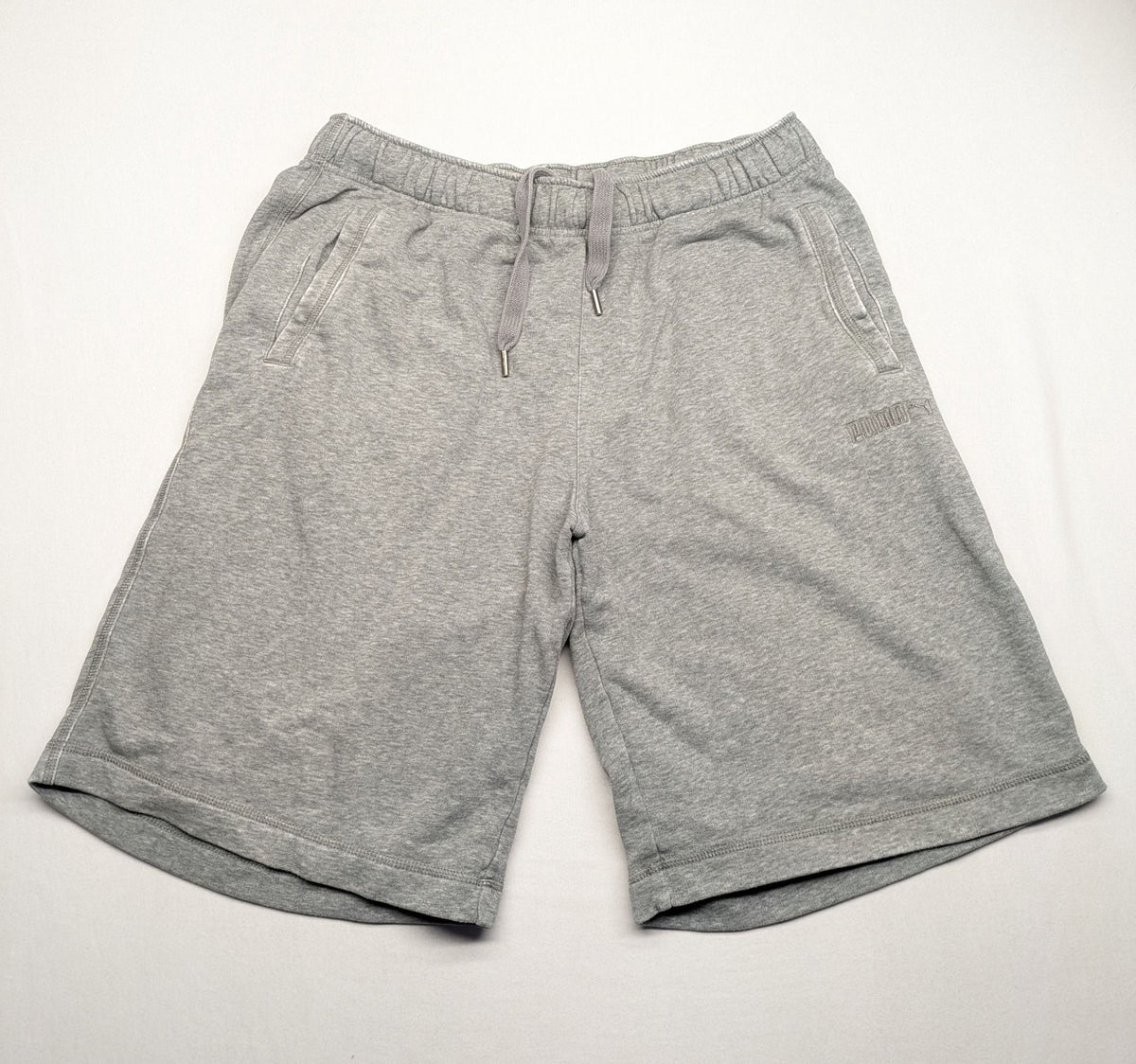Puma grey sweat shorts with embroidered logo, made from cotton-polyester blend.