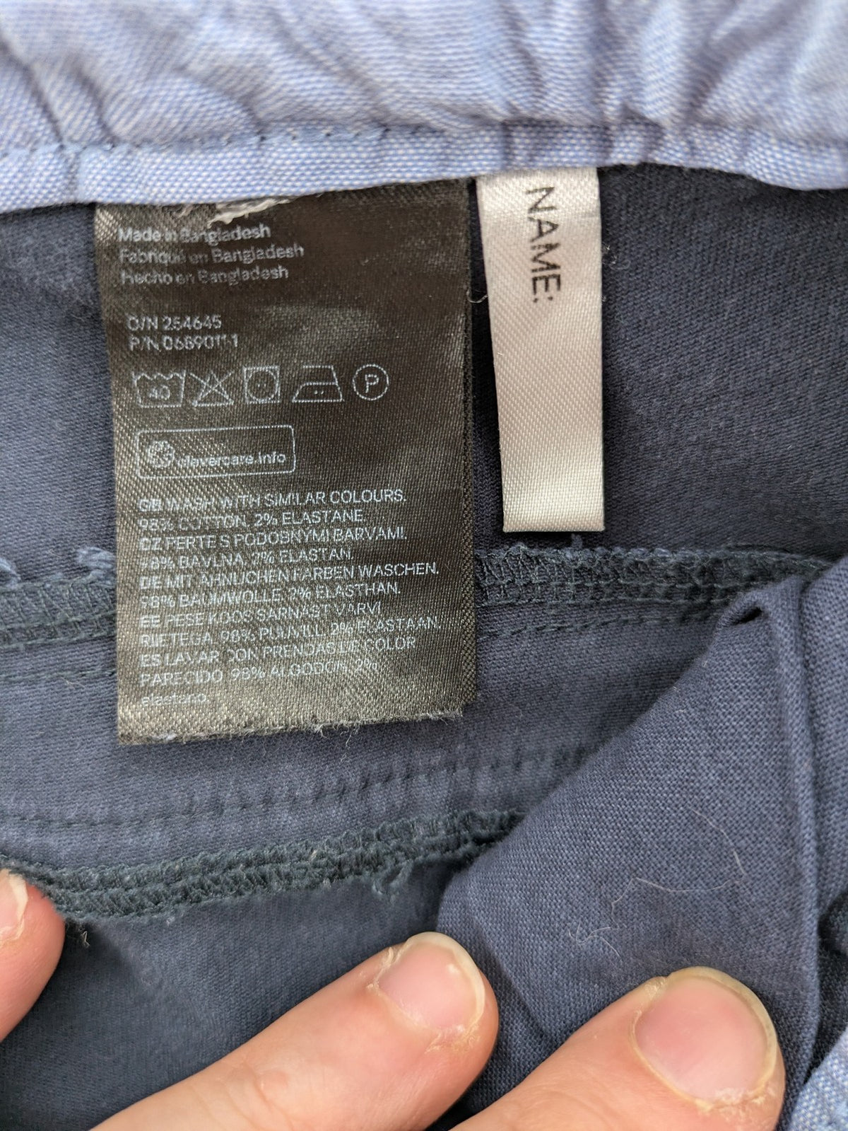 H&M navy chino pants with stretch, classic design, soft cotton blend material.