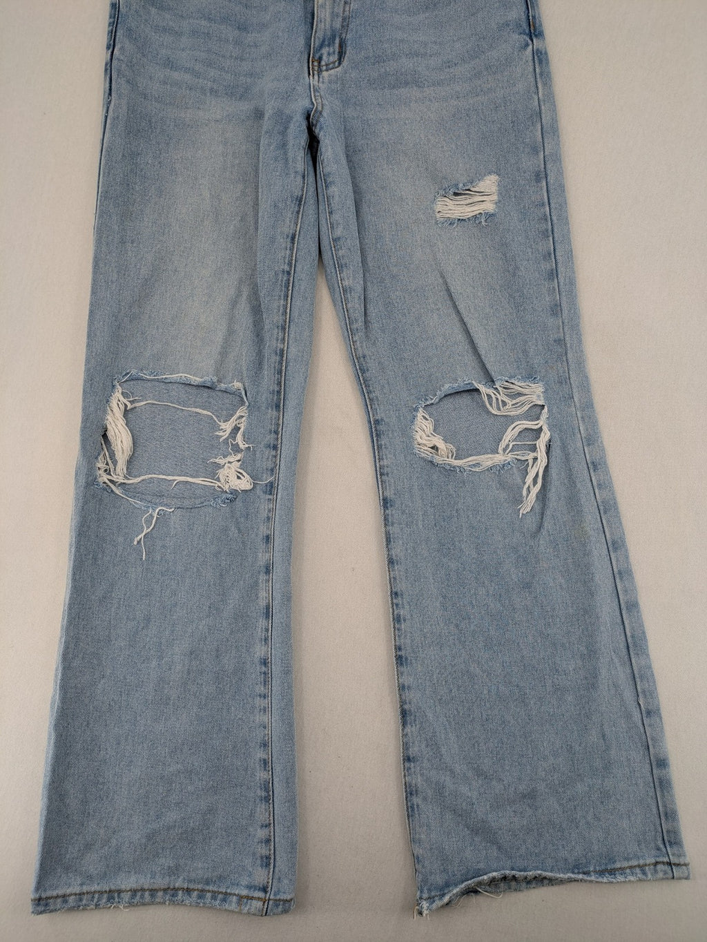 Laulia blue wide leg jeans with distressed knee rips and high waist design.