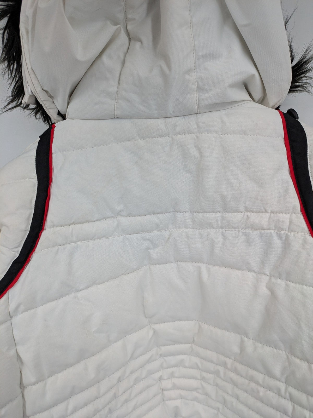 Janina white puffer jacket with quilted design and faux fur hood accents.