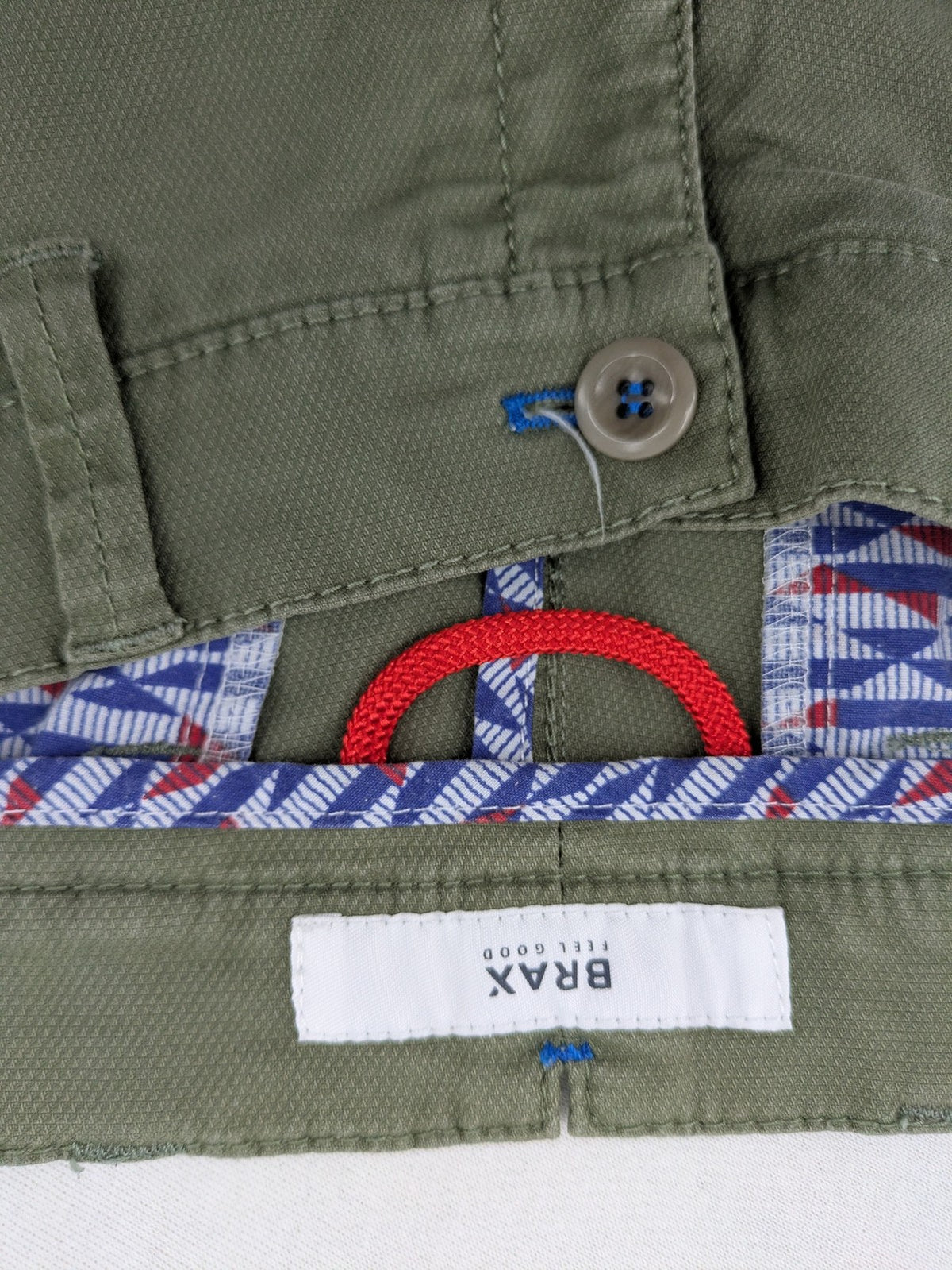 BRAX green chino pants flat-front design with zipper and buttoned back pockets.