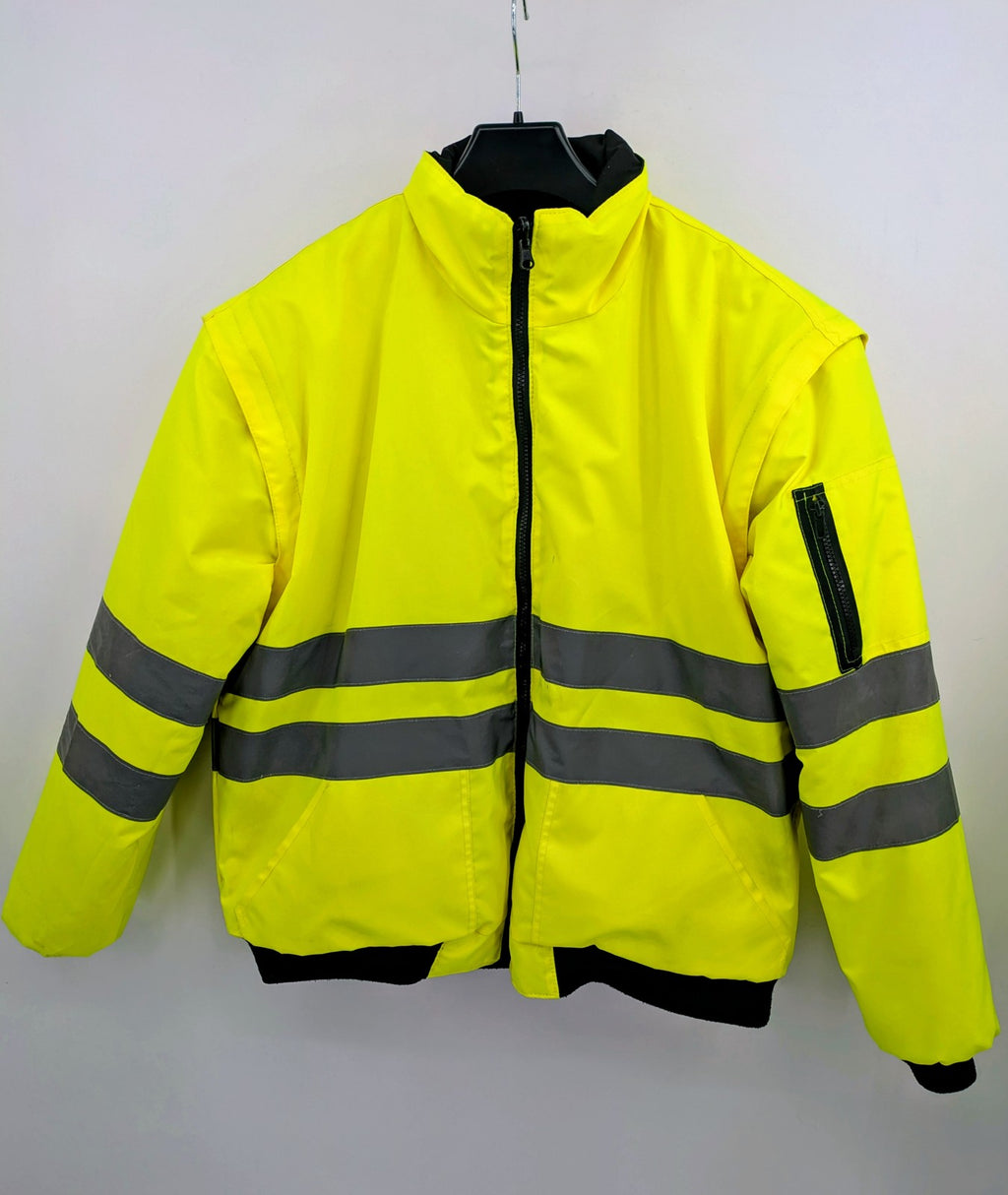 Hüren OHG grey and neon yellow safety jacket with reflective stripes and zippered arm pocket.