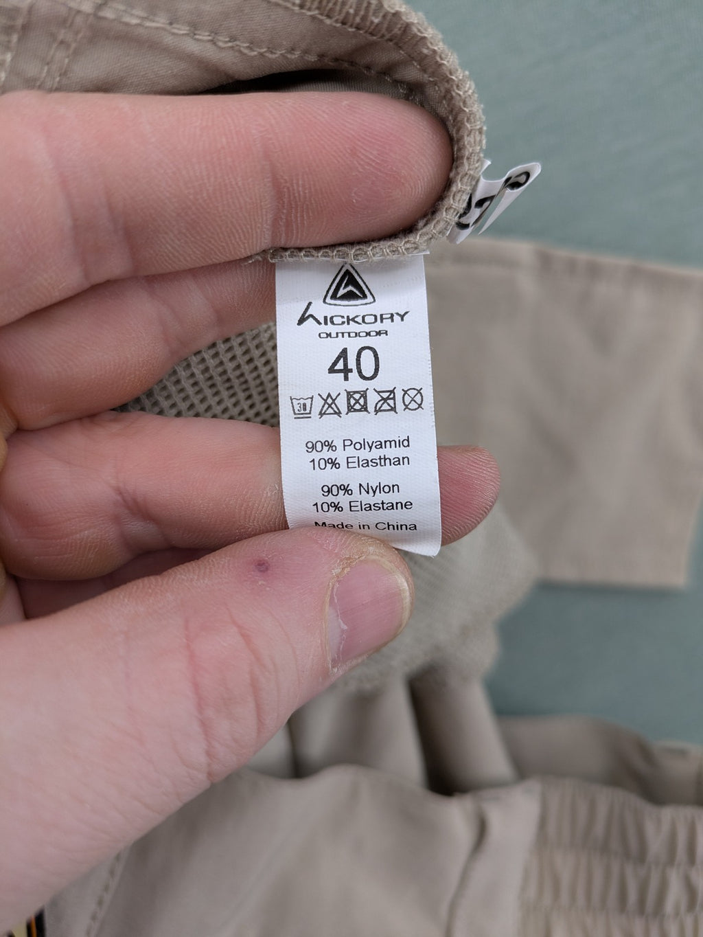 Hickory beige outdoor pants with multiple zippered pockets and stretch fabric for comfort.