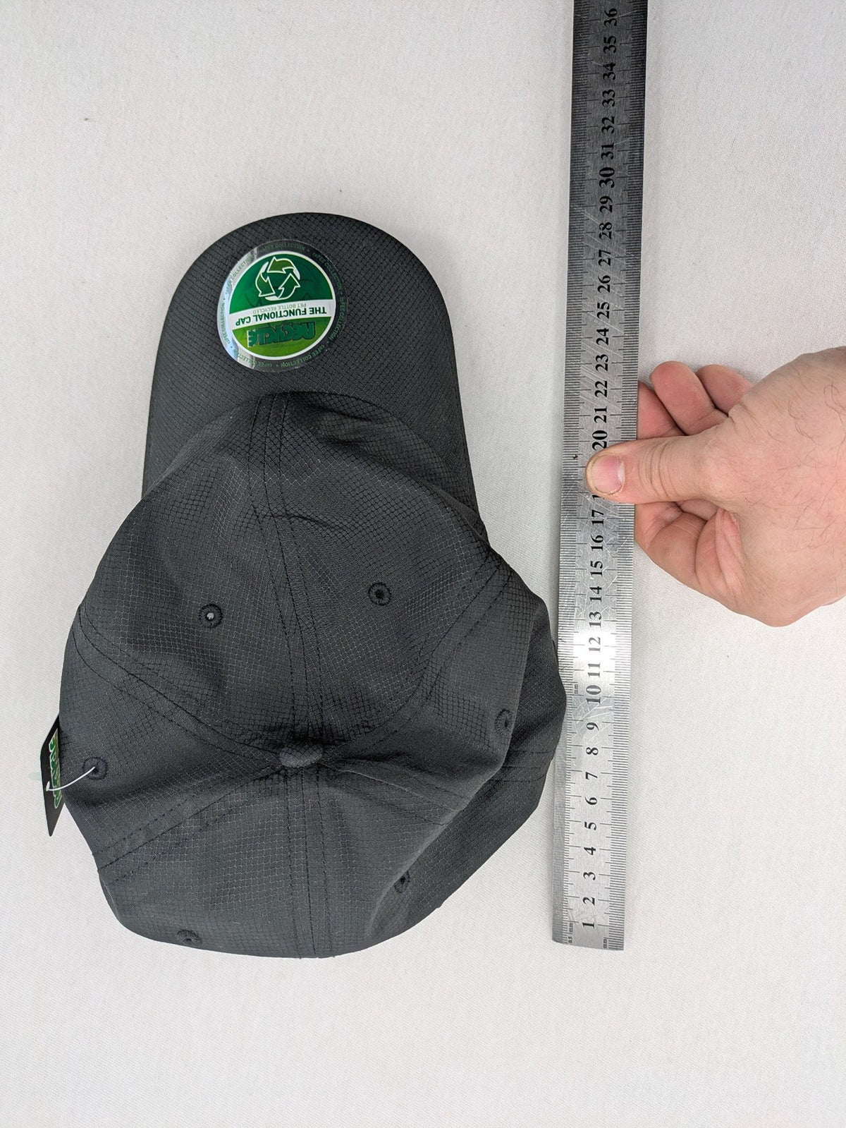 Funktional grey baseball cap with embroidered Dormakaba logo and modern ripstop texture.