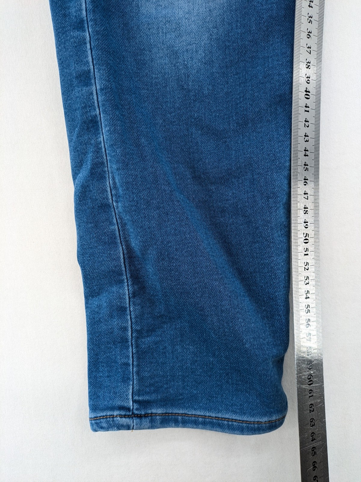 H&M blue straight jeans with elastic waistband and white drawstring, casual jogger style.