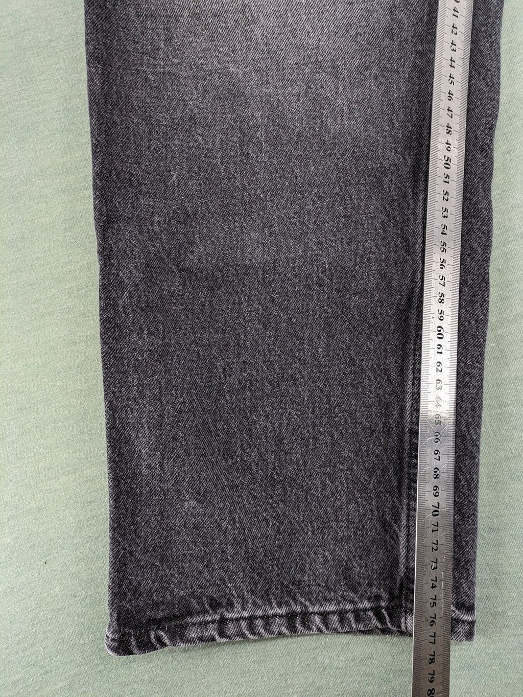 Black Squad black straight jeans with Gothic "Paranoid" lettering and faded finish.