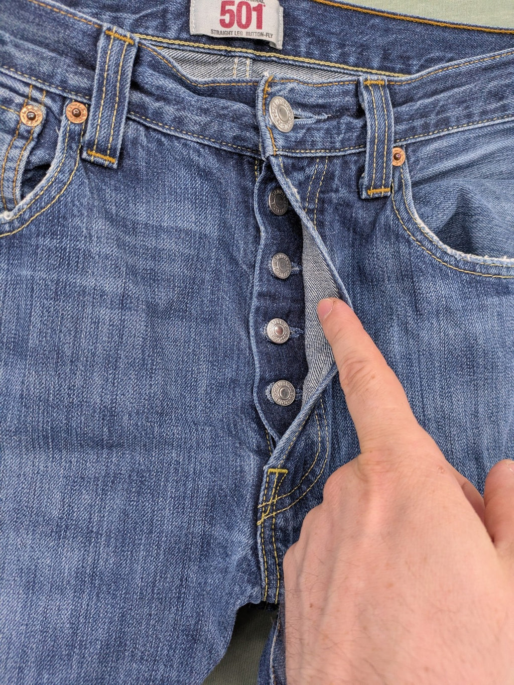 Levi's blue cut-off shorts with frayed hem, classic 5-pocket design, button fly.