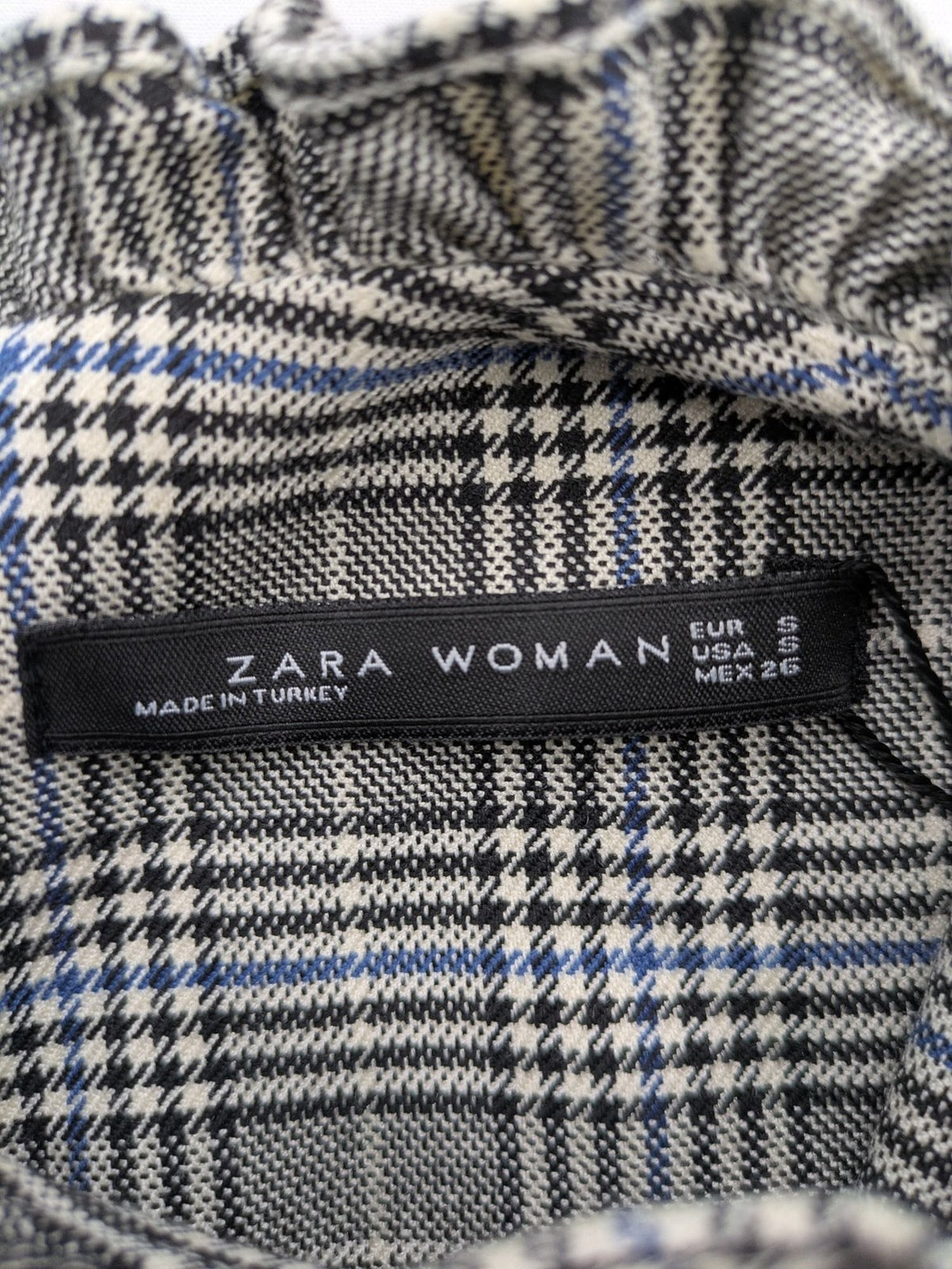 Zara ruffled sleeveless blouse grey check pattern high ruffle collar with blue, black, white accents