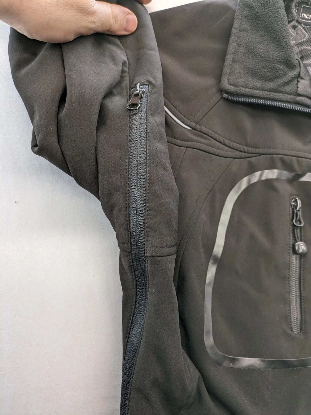 James & Nicholson grey softshell jacket with fleece lining and multiple zip pockets.