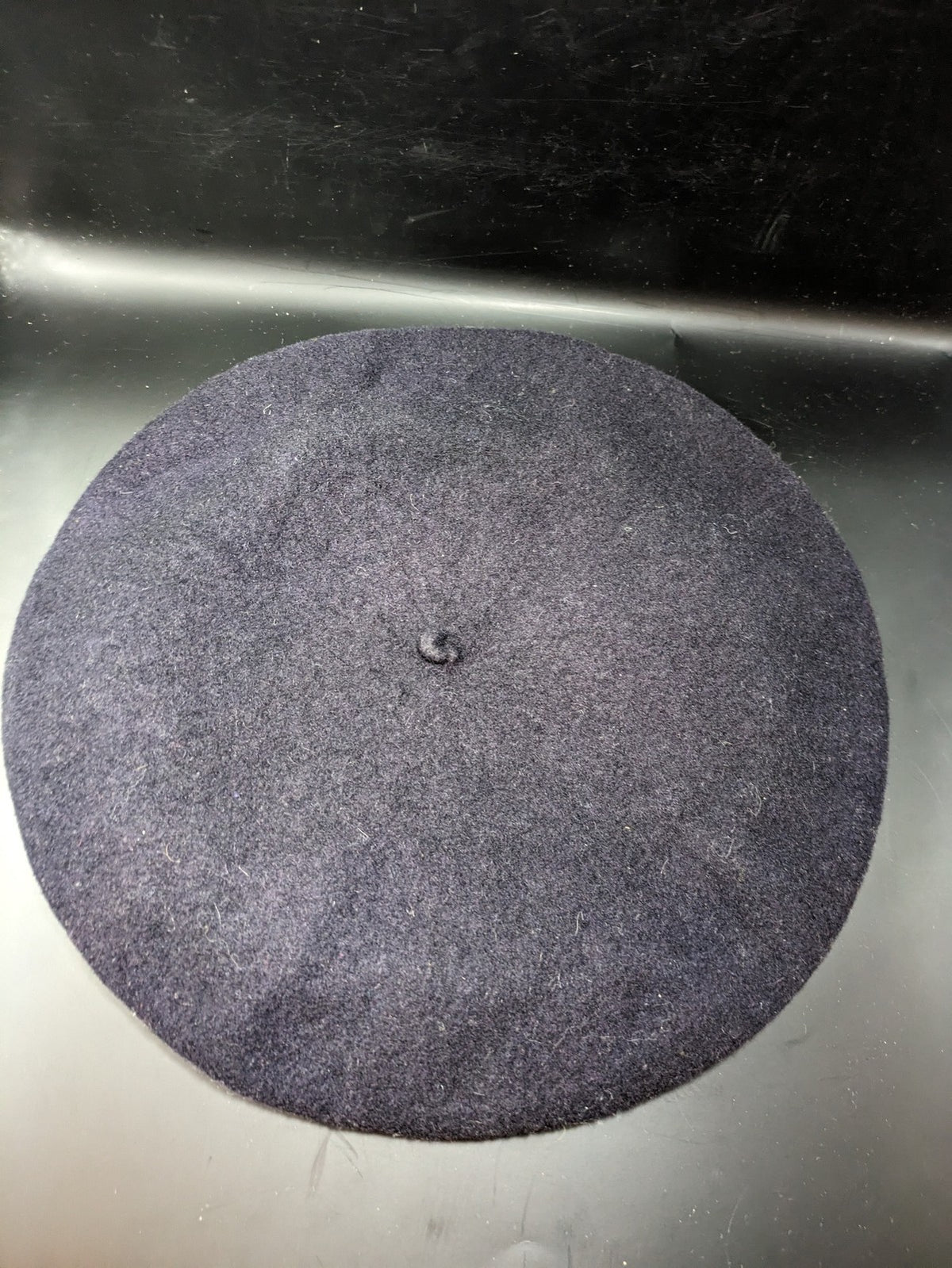 Luxe navy beret pure wool waterproof with emblem lining and leather band.