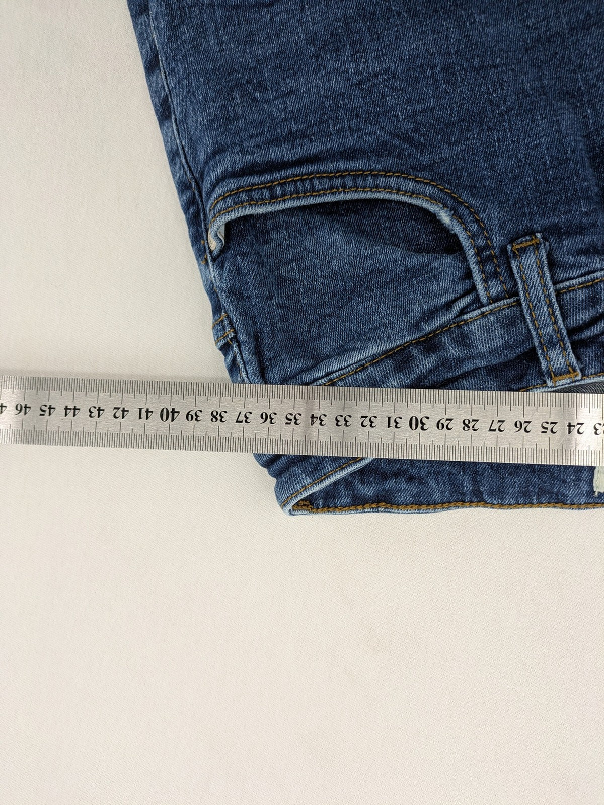 2Y Premium blue skinny jeans with distressed details and classic button fly.
