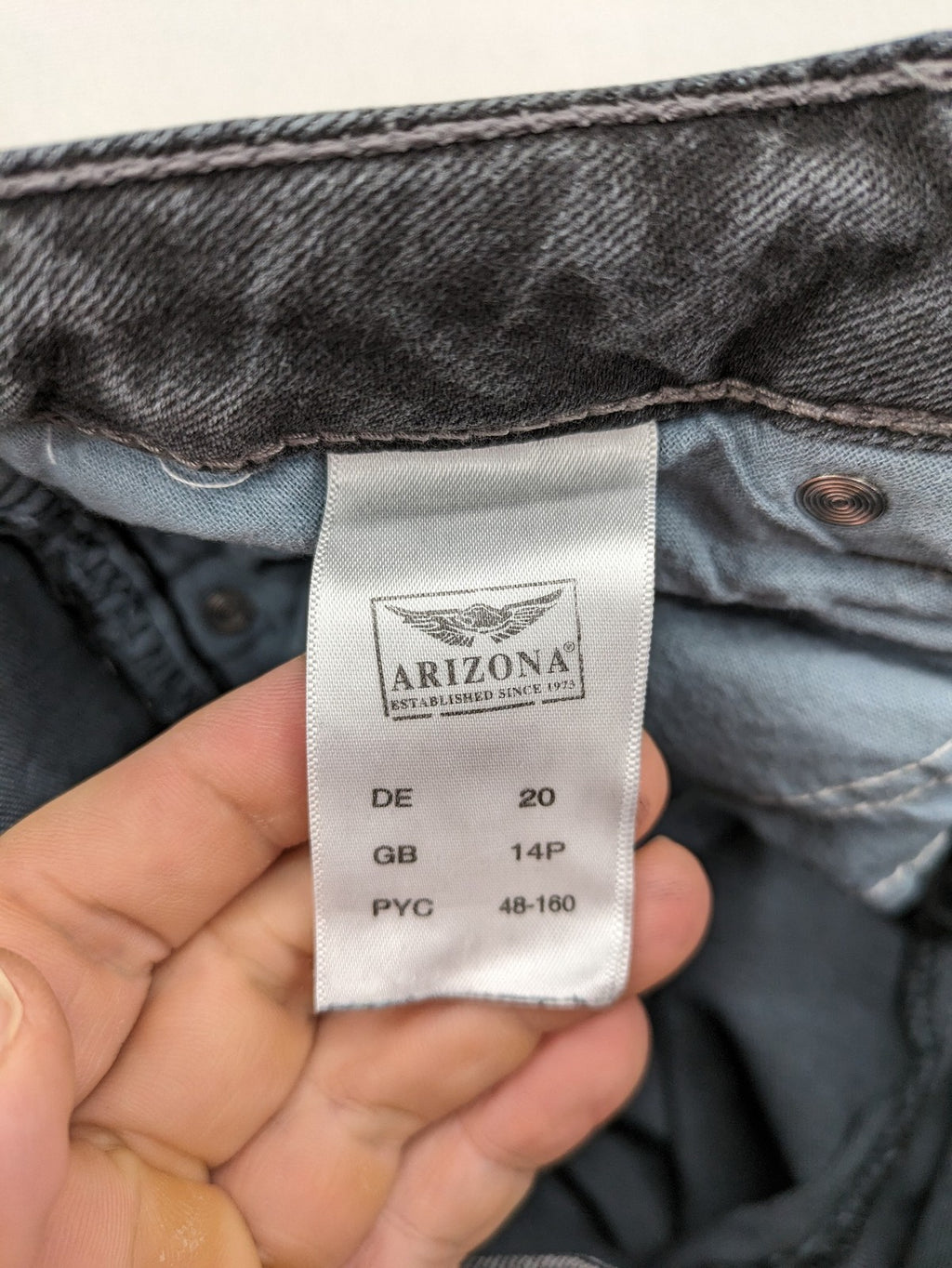 Arizona grey straight jeans with pearl-embellished wing appliqué on back pocket.