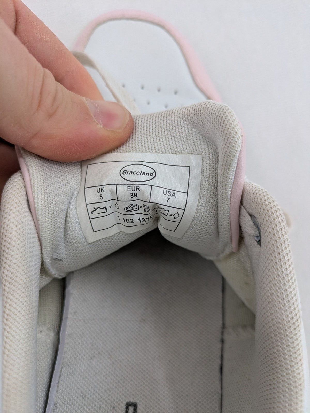 Graceland white sneakers with pink and mint green accents, low-top design, cushioned tongue.