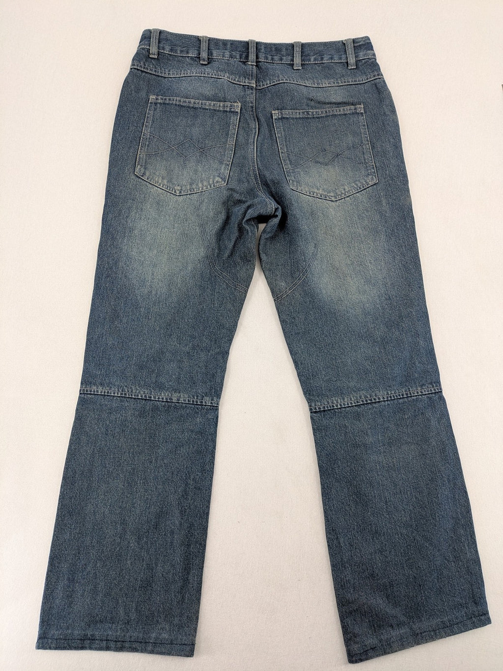John F. Gee blue straight jeans with reinforced knees and durable denim material.