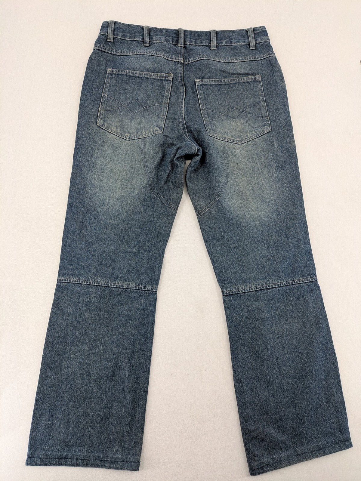 John F. Gee blue straight jeans with reinforced knees and durable denim material.