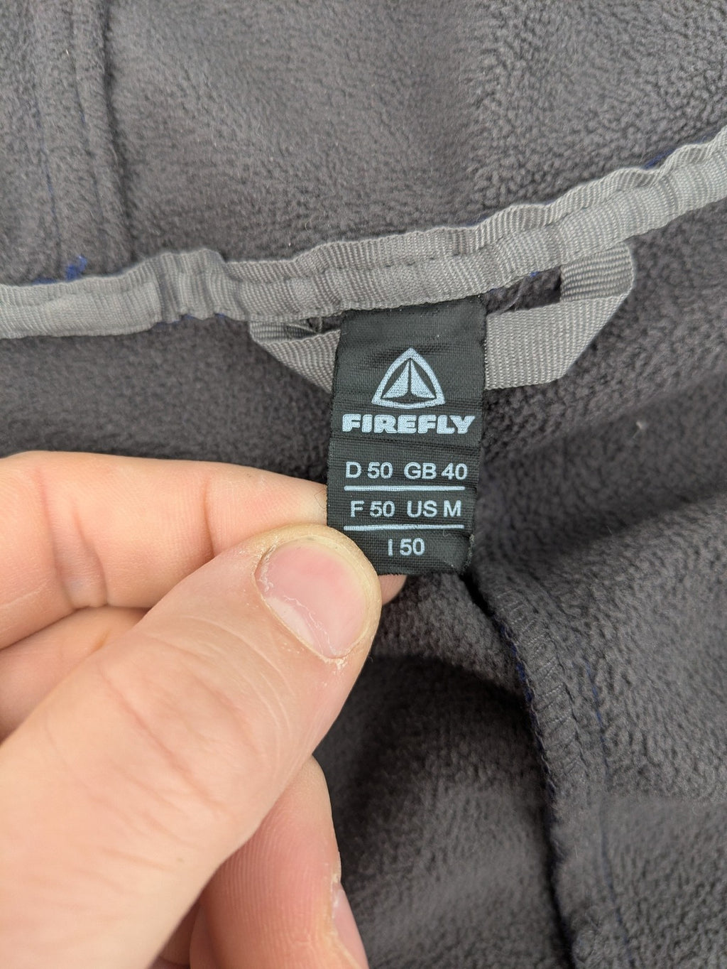 Firefly blue softshell jacket with adjustable hood and prominent chest logo.