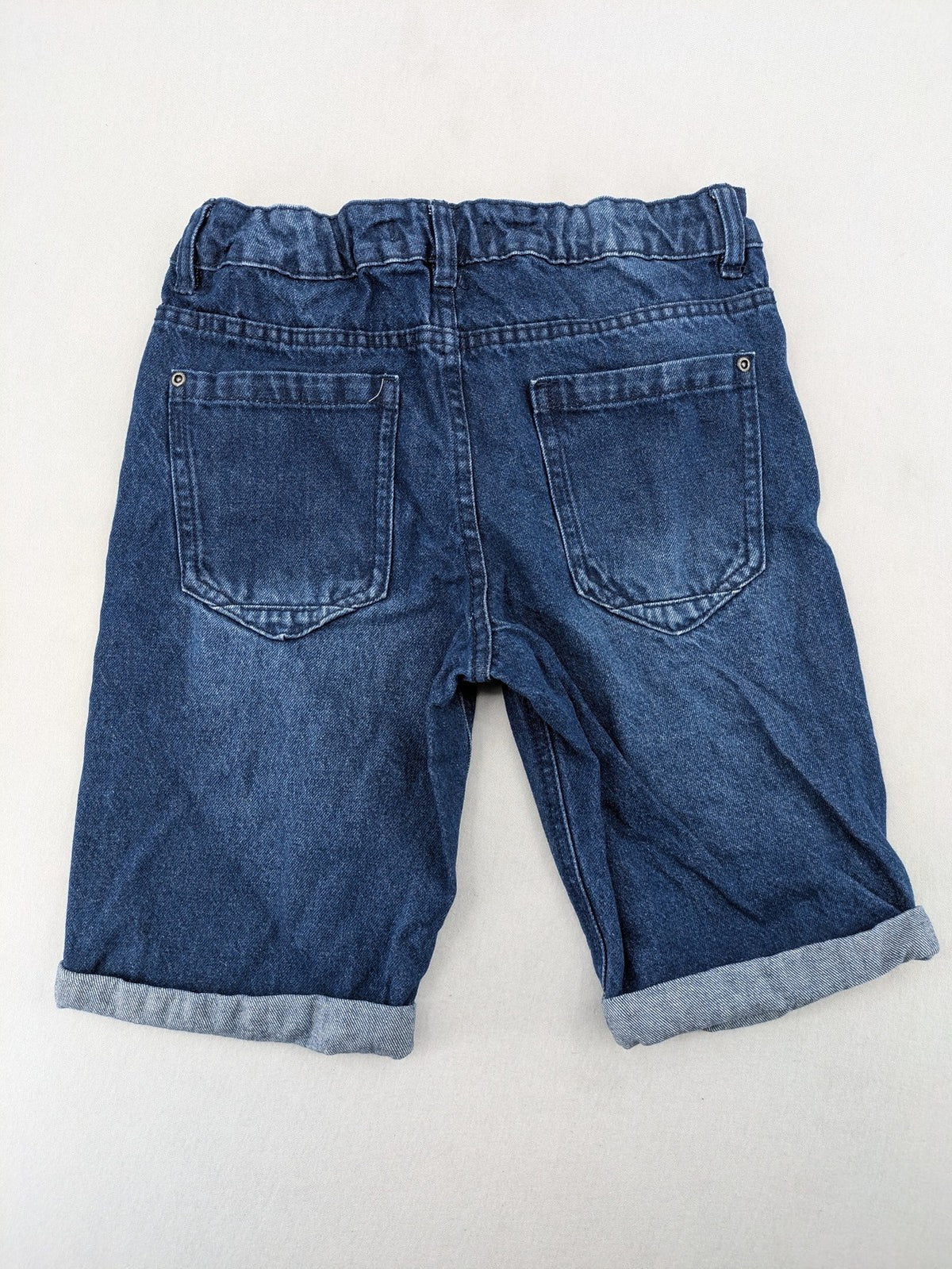 Pocopiano blue denim shorts with rolled cuffs and elastic waistband for comfort.