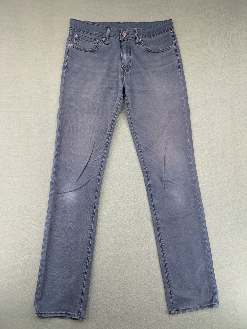 Levi's blue slim fit jeans with faded wash and classic 5-pocket design.