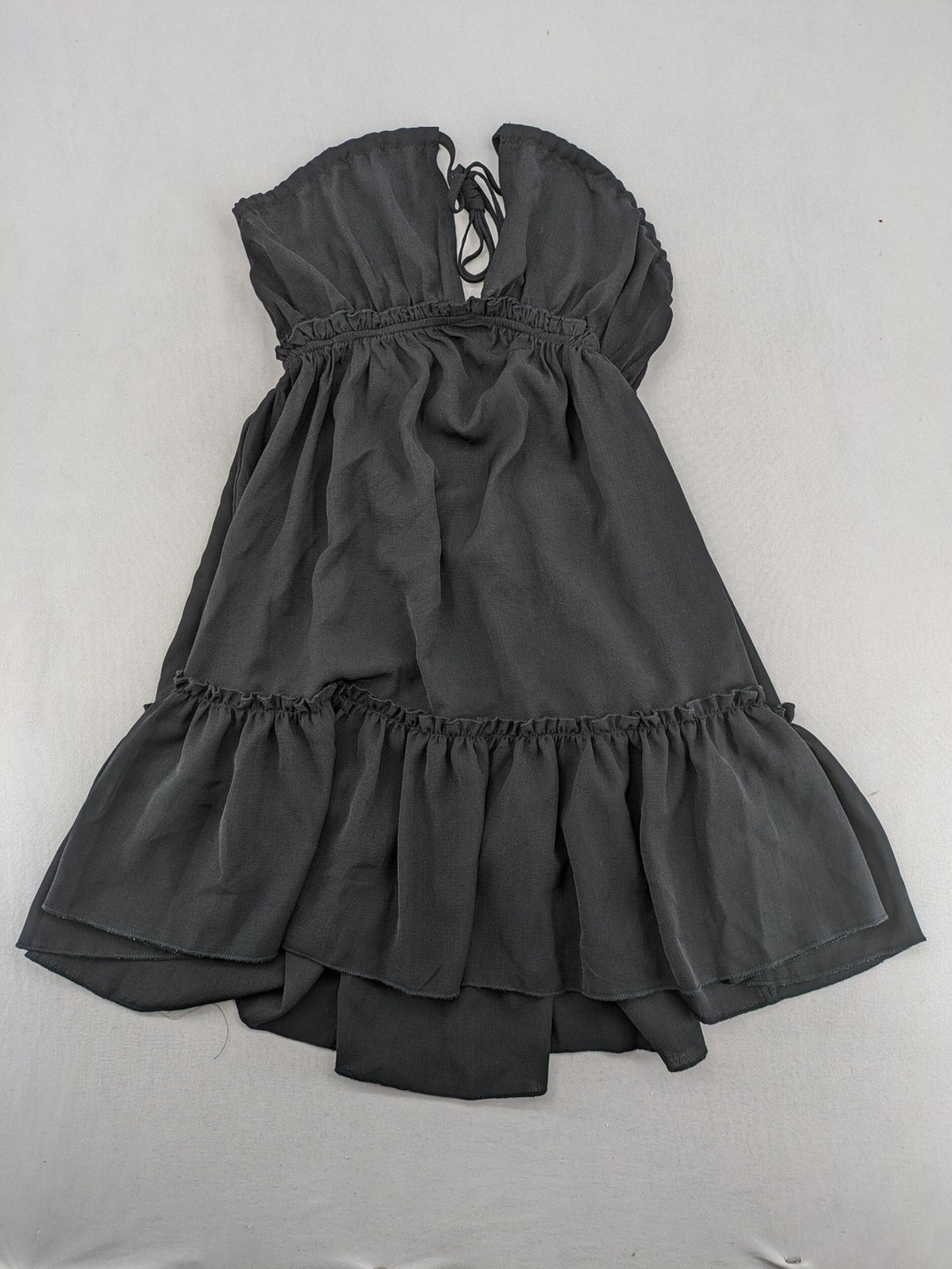 SHEIN grey mini dress with open back, adjustable tie, and ruffled hem.