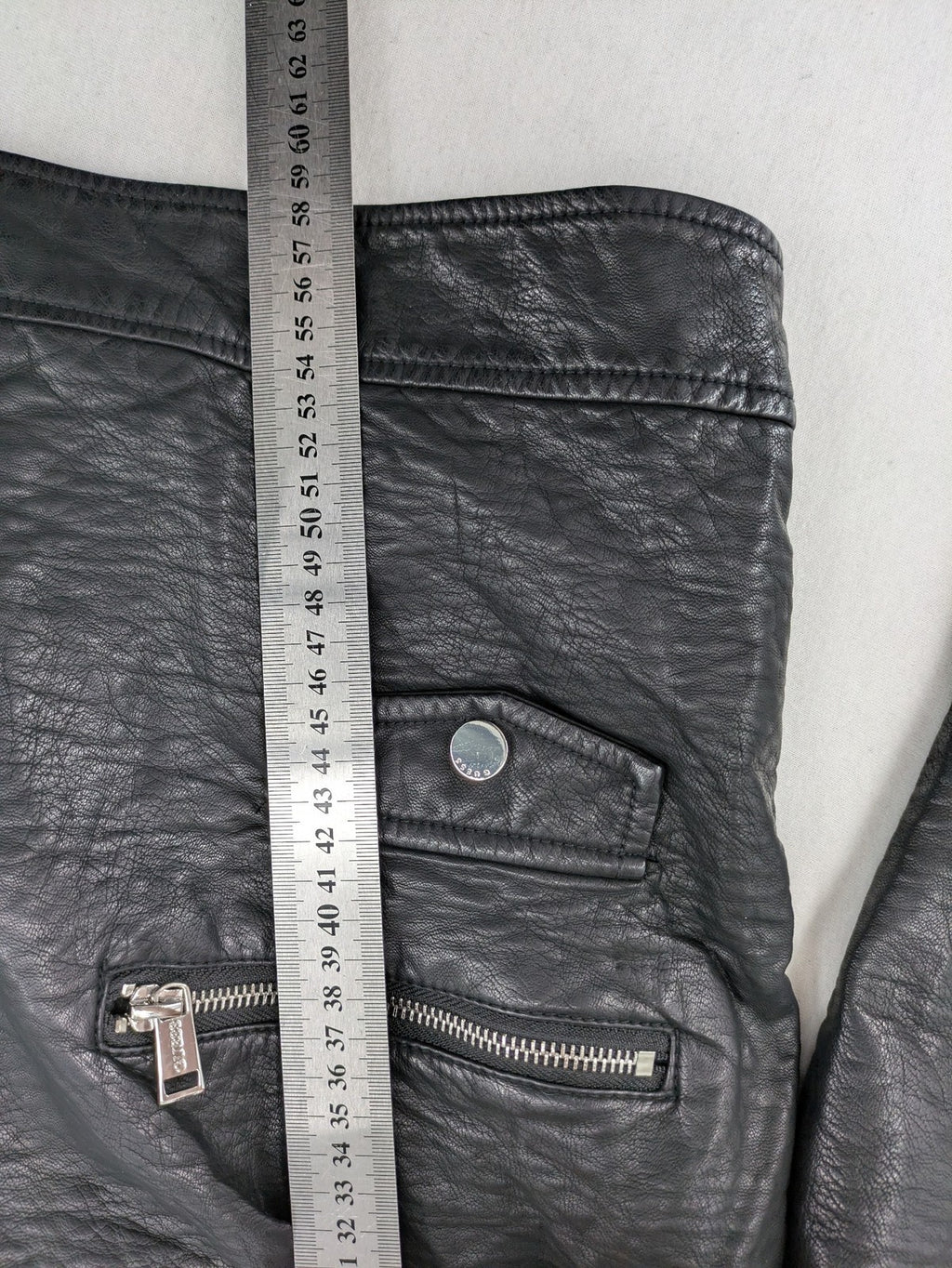 Guess black faux leather biker jacket with asymmetric zipper and multiple zip pockets.