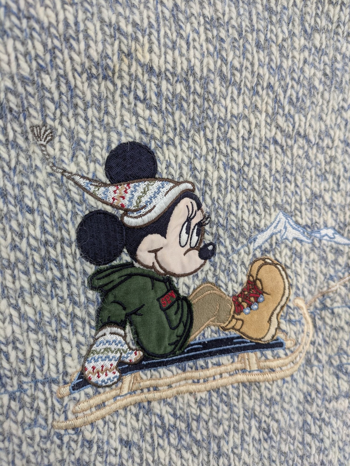 Disney blue turtle neck jumper with grey Mickey and Minnie Mouse embroidery, zip closure.