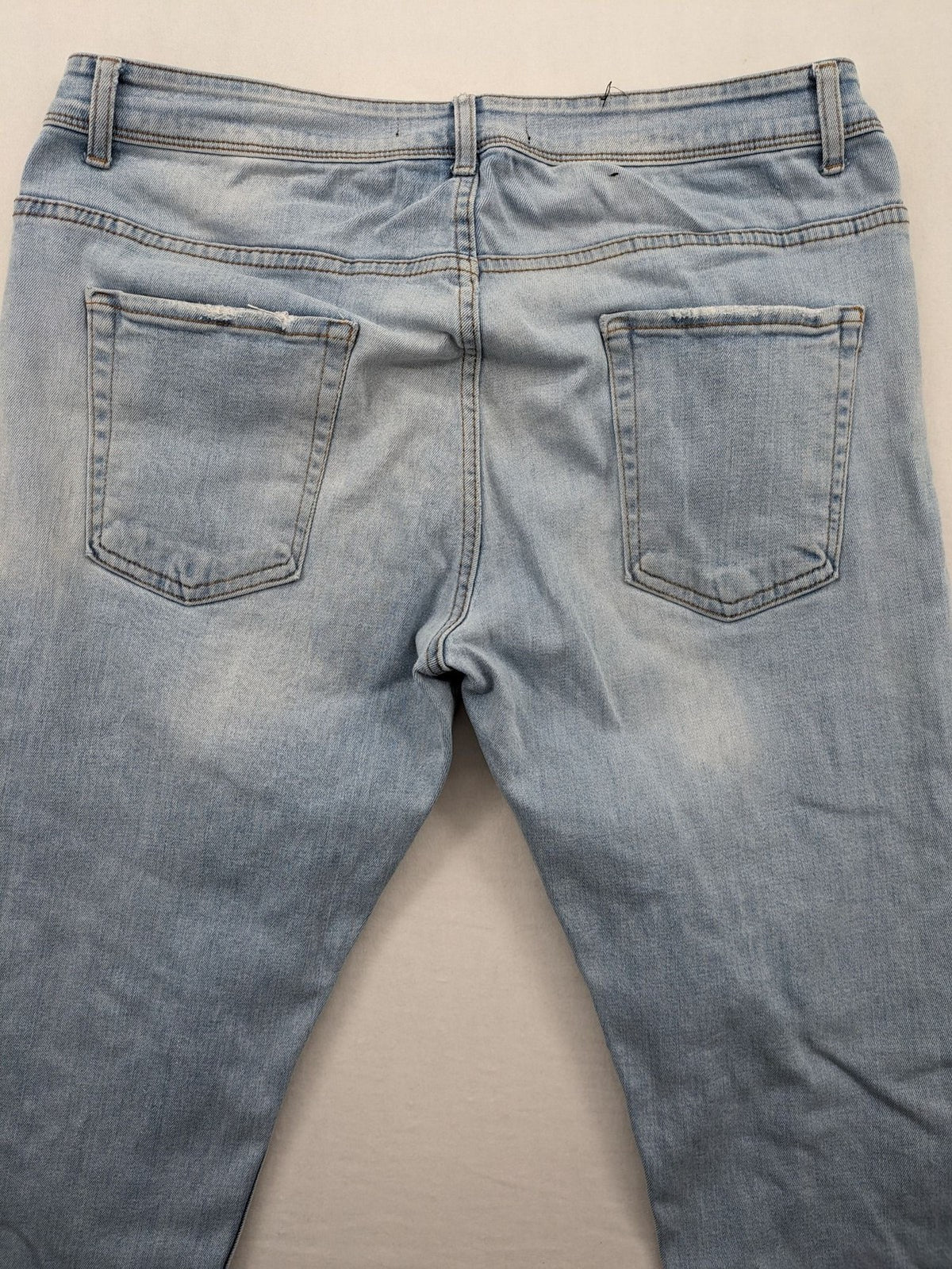 i8 Denim blue straight jeans destroyed look with frayed hems and classic button fly.