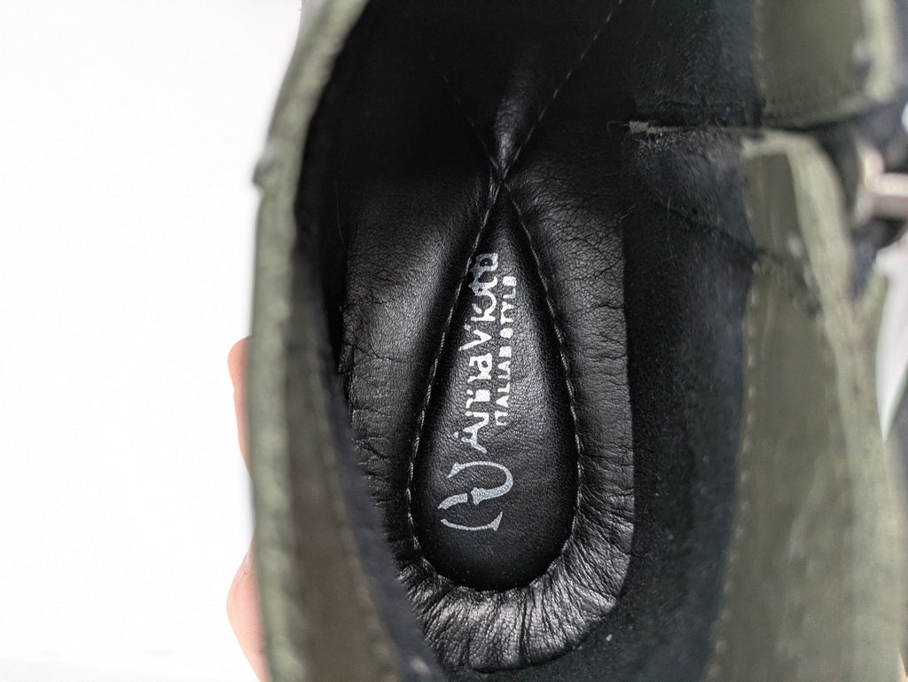 ALS green leather booties with side zipper and decorative stitching.