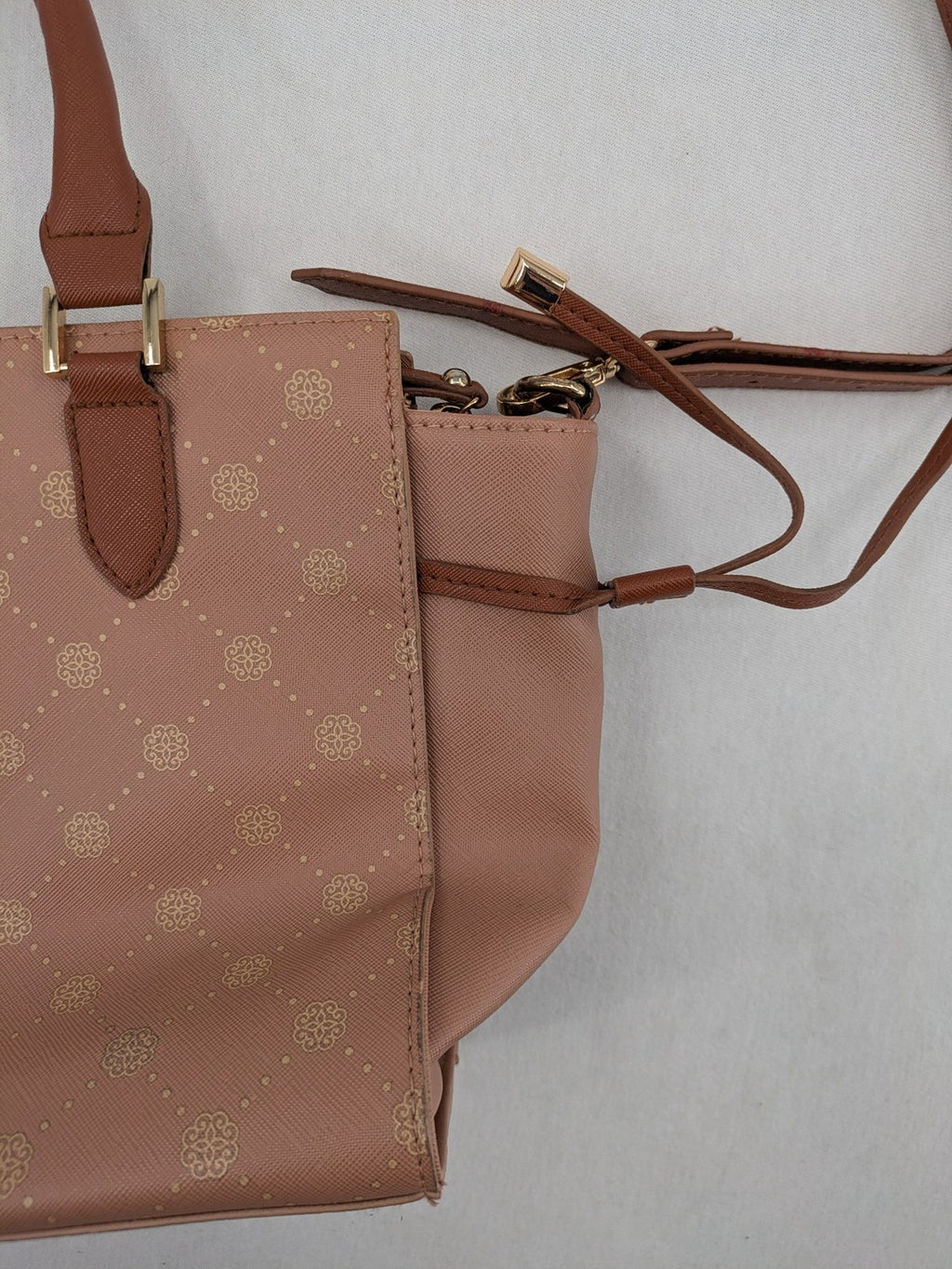 Catwalk gold handbag with pink and brown monogram pattern, adjustable shoulder strap.