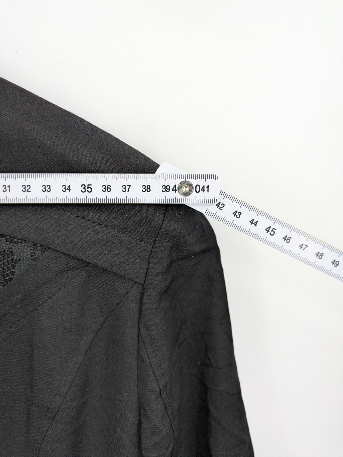 Alvina black trench coat with lace collar and gold buttons, belted waist design.