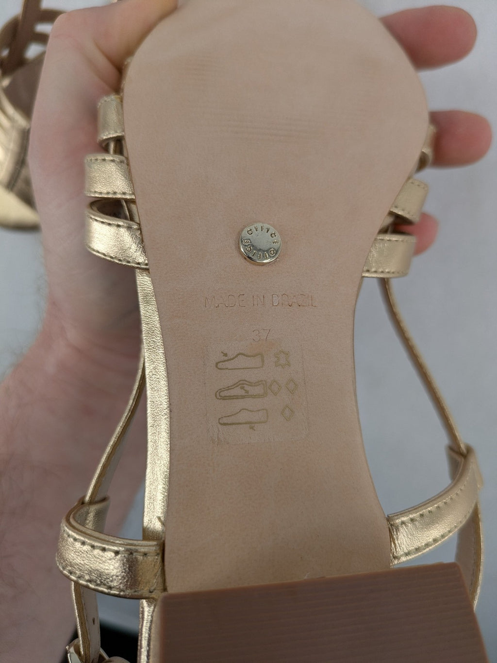 Office London gold metallic sandals with adjustable ankle strap and block heel design.