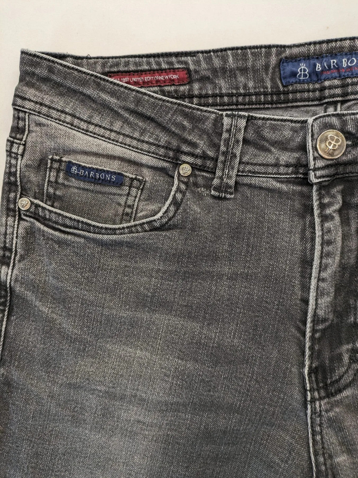 Denim grey straight jeans 5-pocket design with subtle brand details and zipper closure.