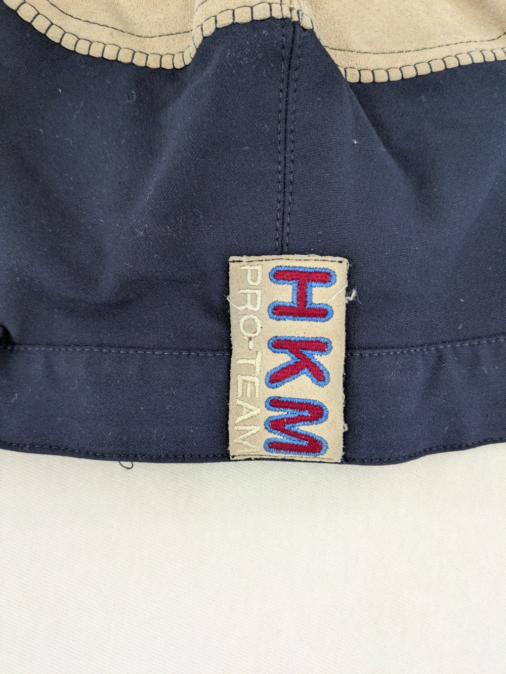 H&KM beige riding pants with dark blue full seat and front zippers.