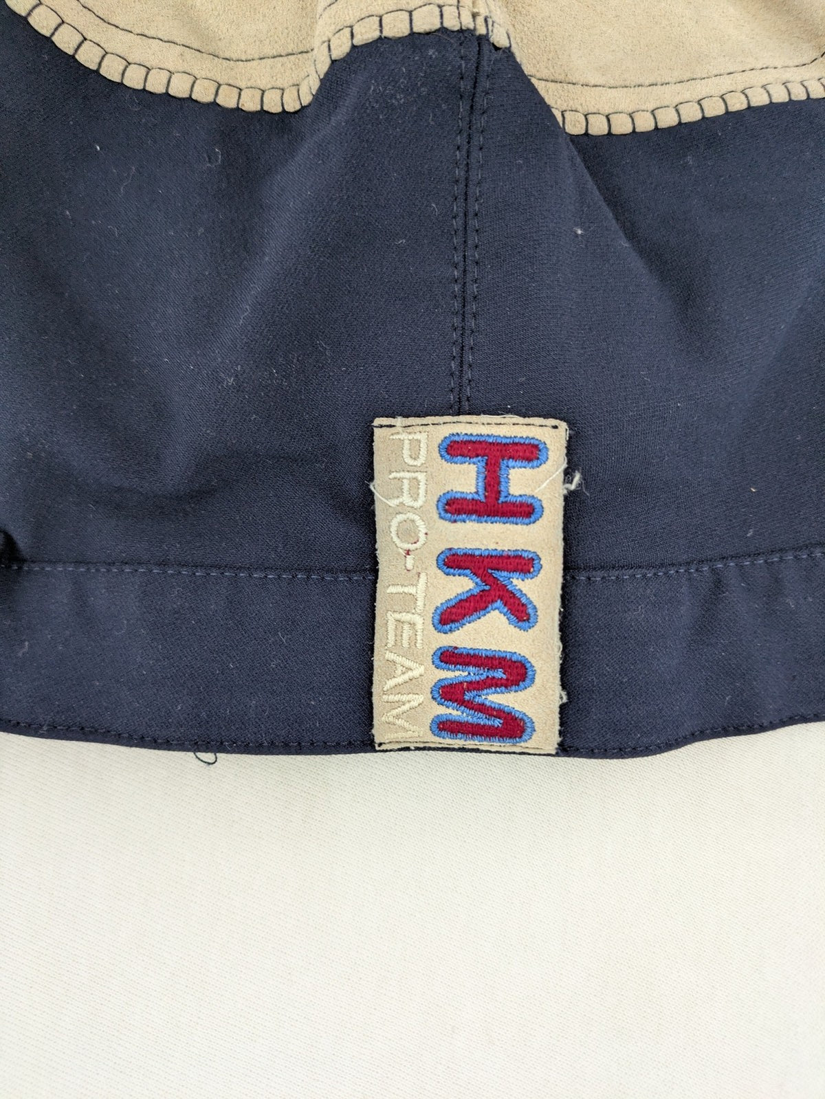 H&KM beige riding pants with dark blue full seat and front zippers.