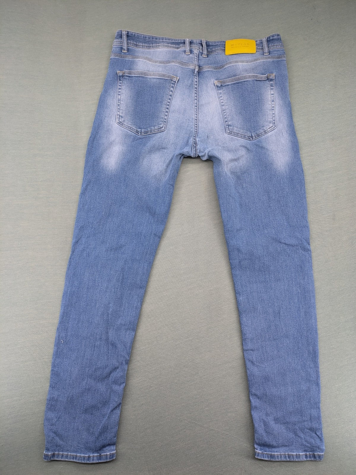 Wotega blue straight jeans light wash faded with classic 5-pocket design and stretch material.