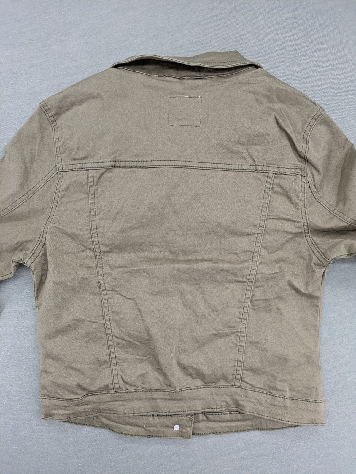 Hailys khaki denim jacket with button closure, two chest pockets, and side pockets.