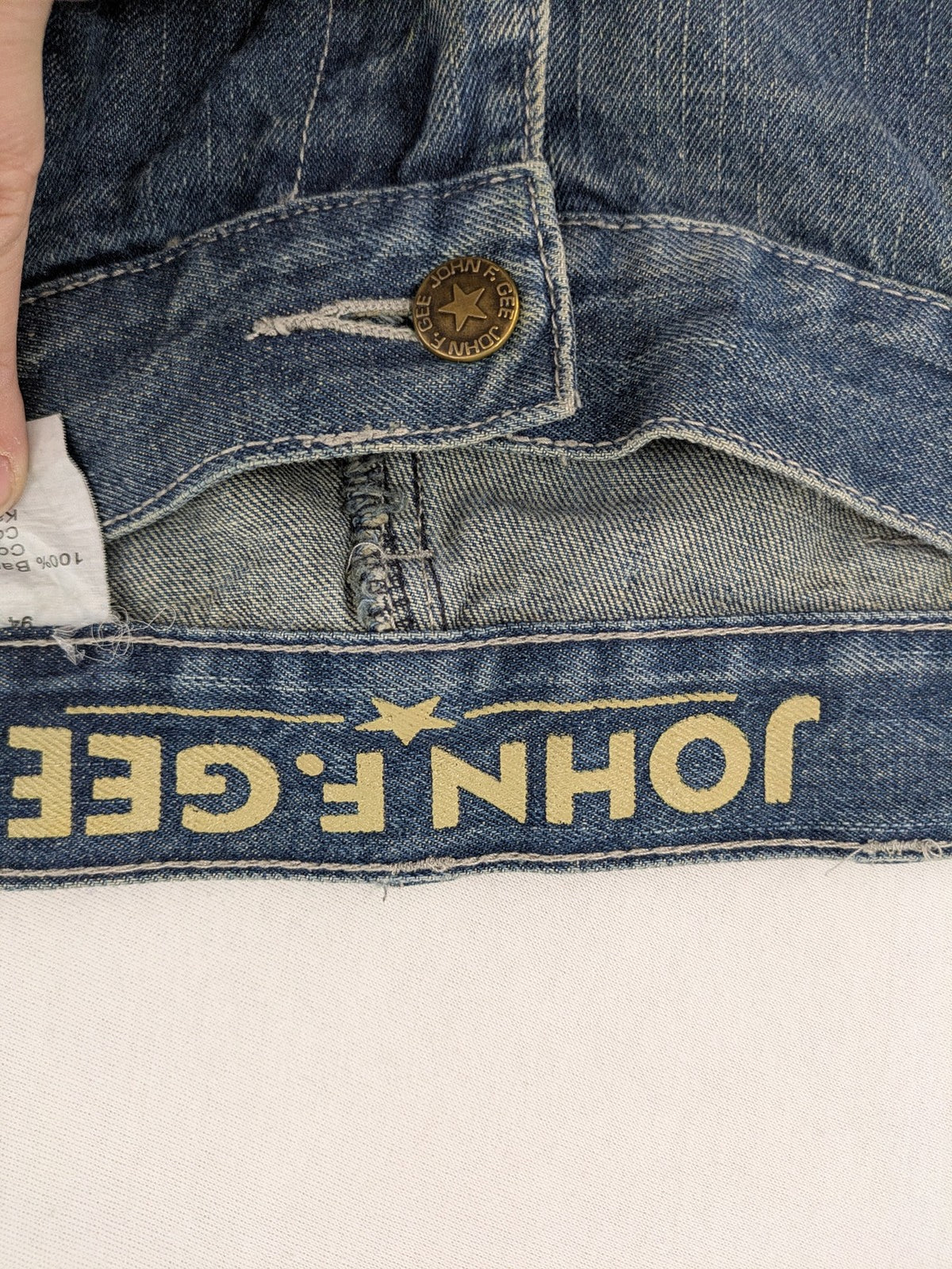 John F. Gee blue straight jeans with reinforced knees and durable denim material.