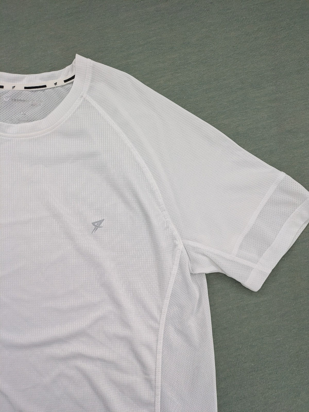Smilodox white workout t-shirt with logo on chest and reflective detail on back.