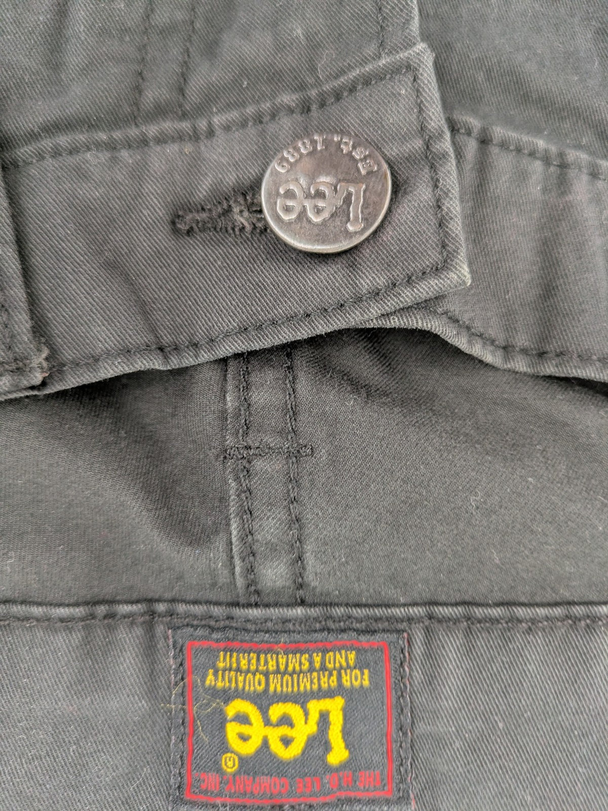 Lee straight jeans grey classic 5-pocket design with zip fly and subtle branding.